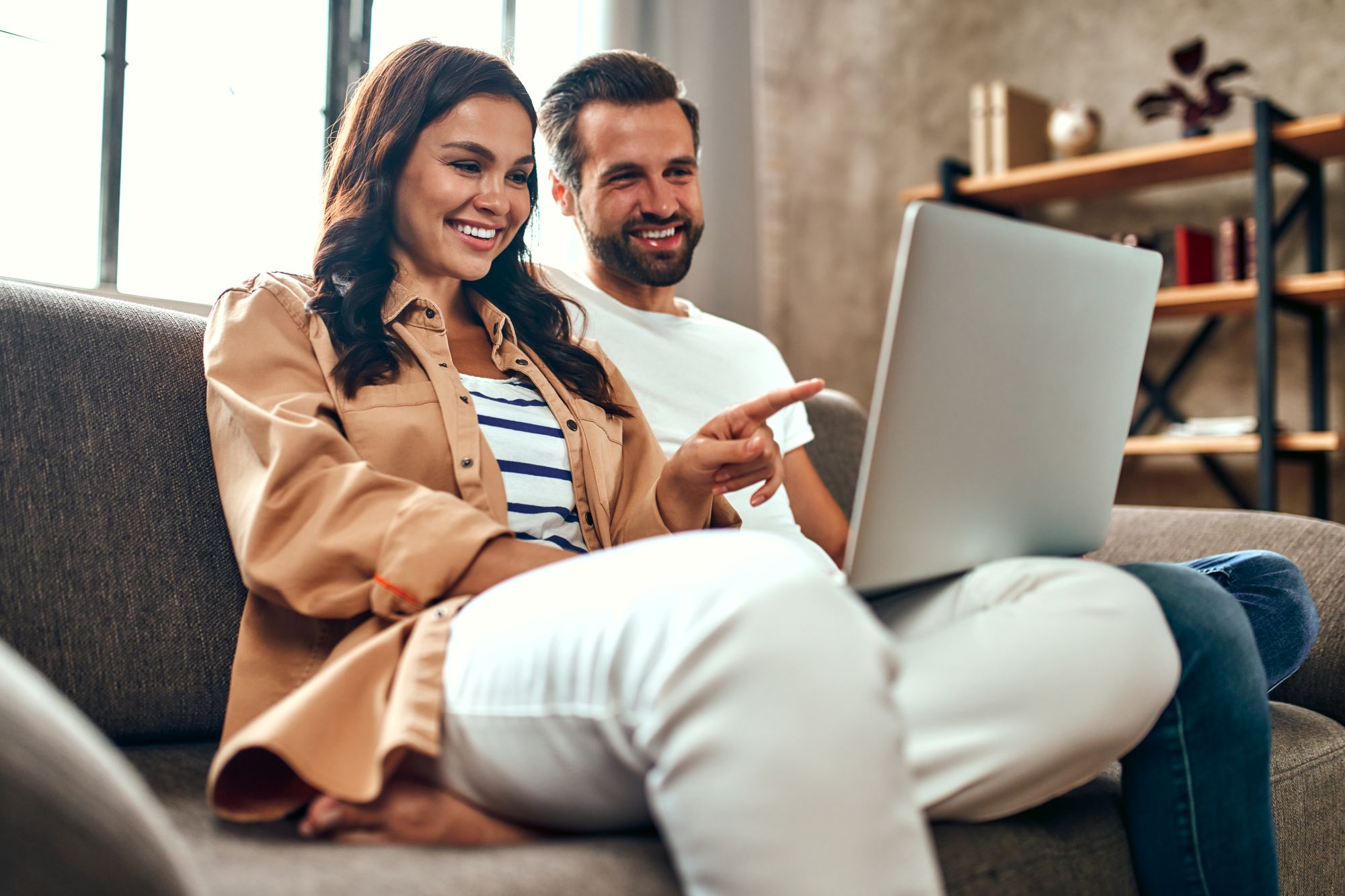 Couple smiling at laptop