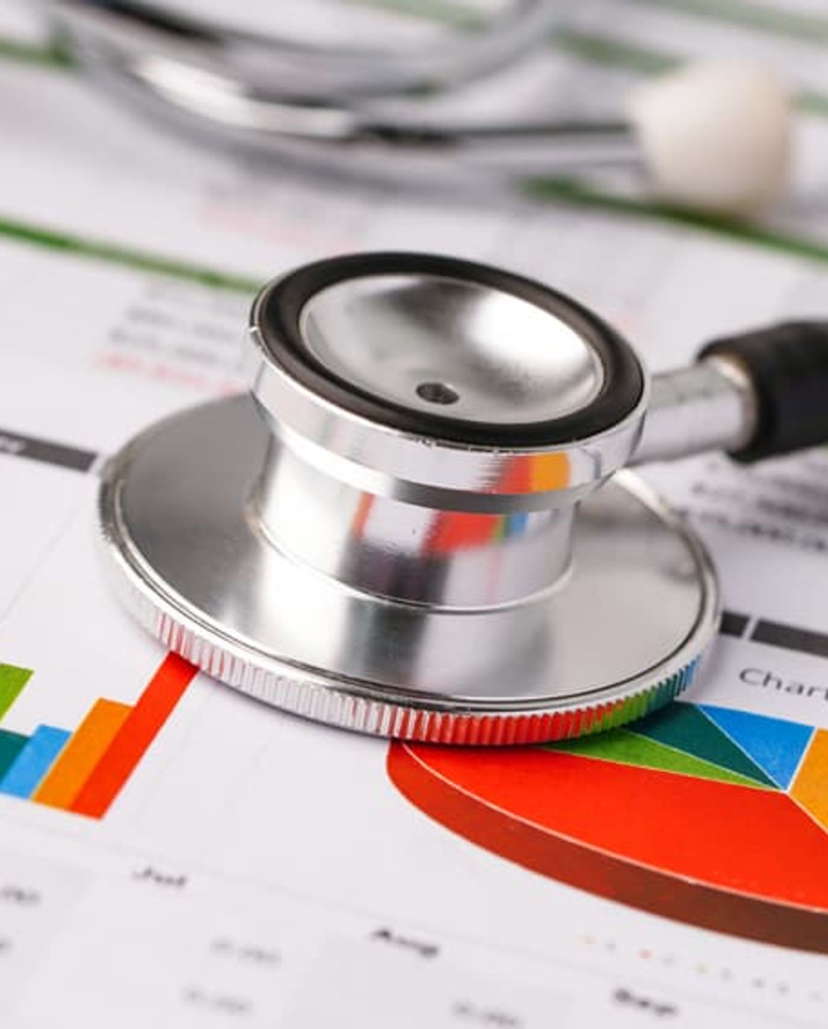 stethescope on top of paper with charts